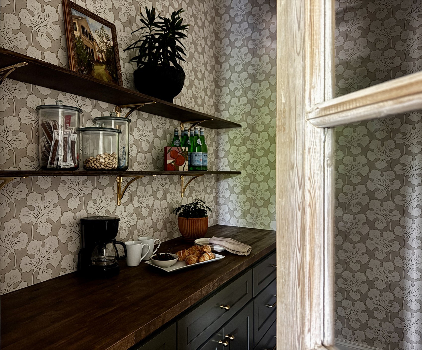 Kitchen island detail with ceramic vase, citrus, and cherries.