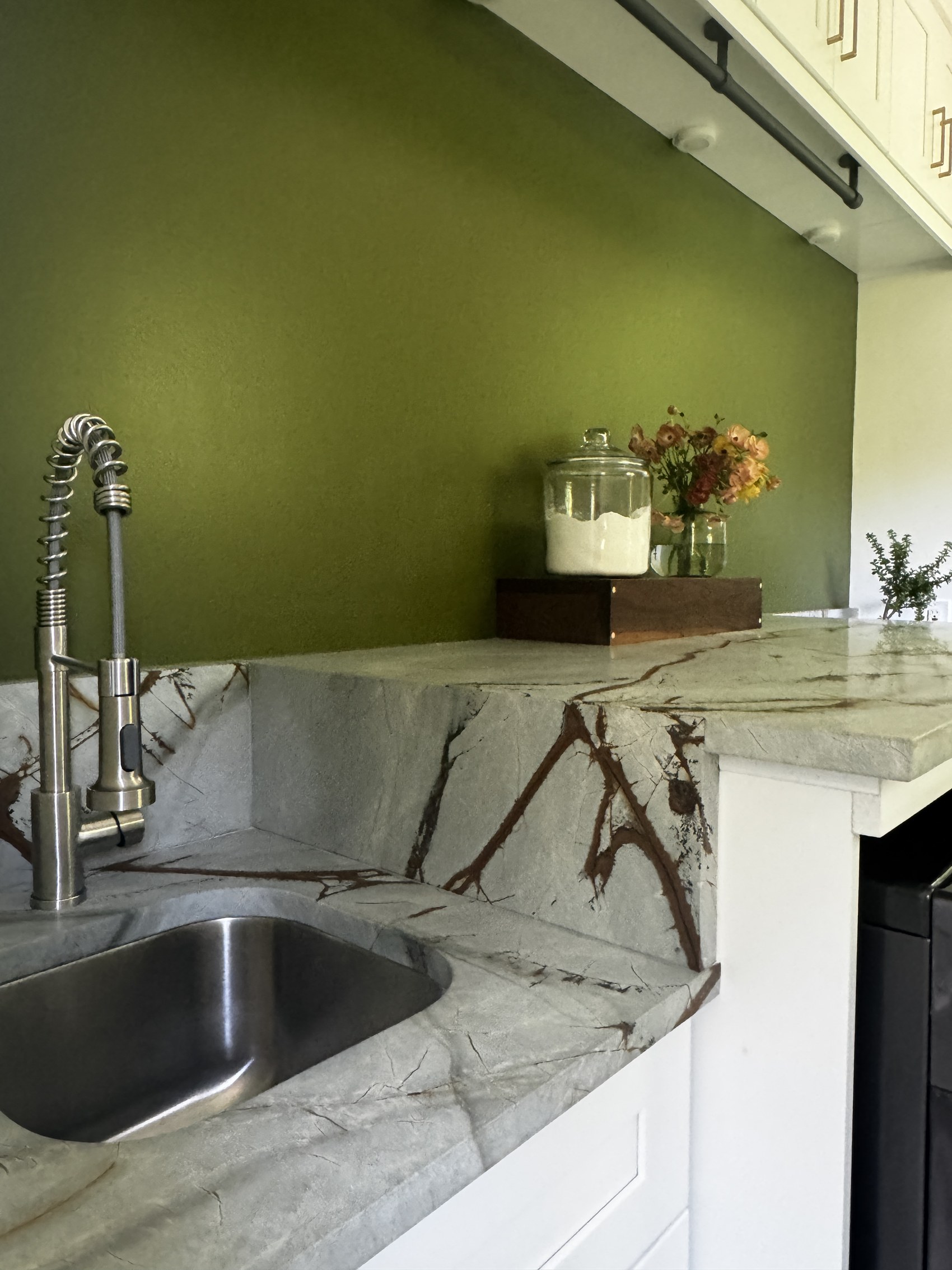 Detail of marble waterfall counter and utility sink in the laundry room.