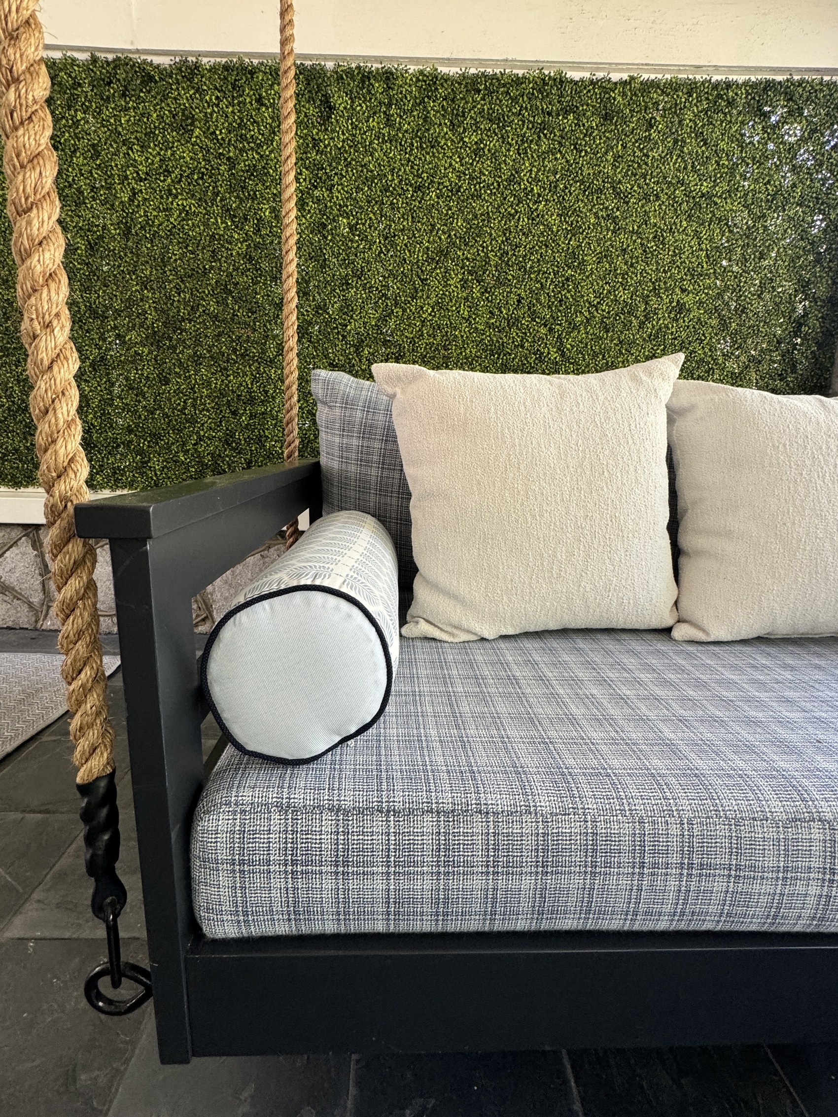 Detail of porch swing bed pillows and rope hardware.