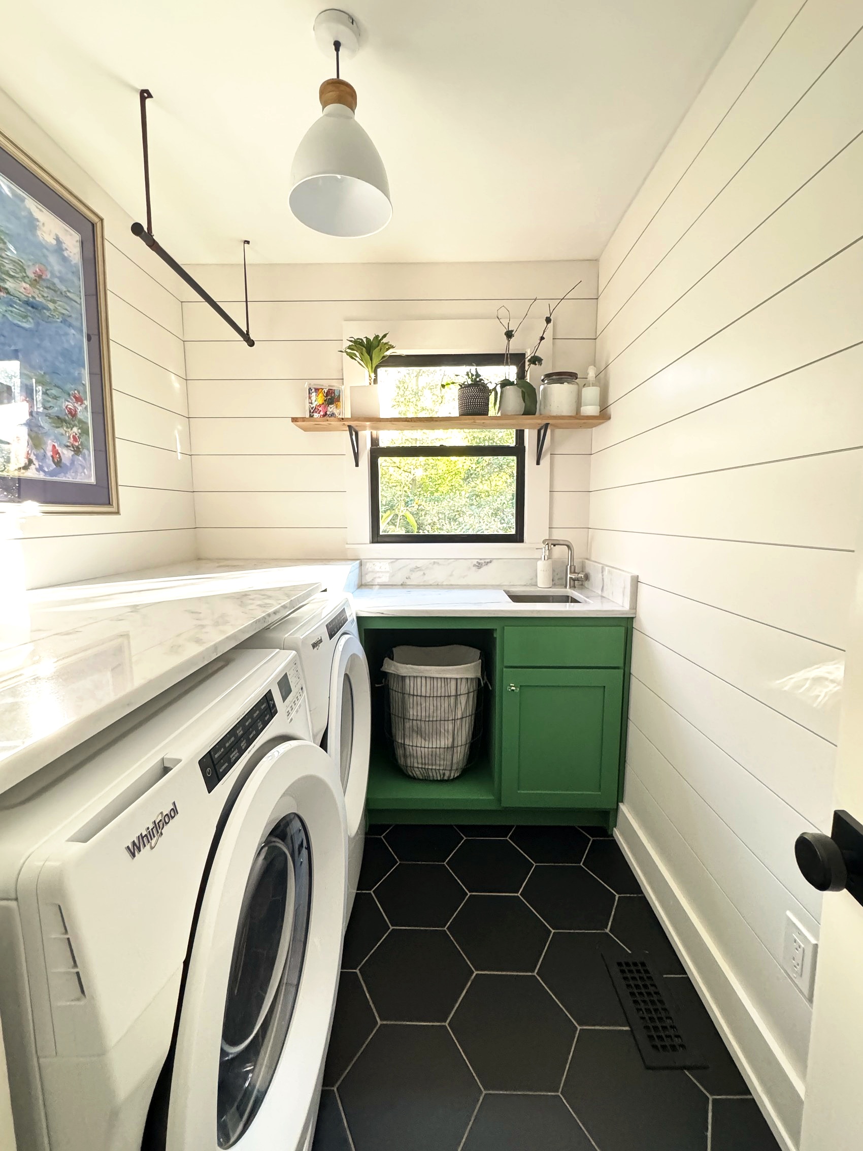 Kitchen with a vintage runner rug and navy range.